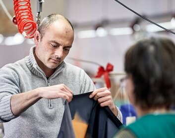 Mitarbeiter der Näherei der Zingerle Group überprüft die Qualität des Zeltstoffes