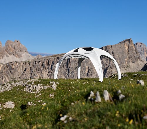 Bedruckter Luftpavillon auf grüner Bergwiese in den Dolomiten